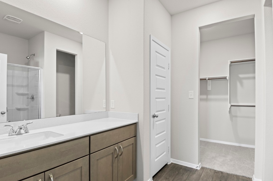 108 Summer Drive Elgin, TX 78621 - Photo 27 of 35 a bathroom with a double vanity sink and a mirror