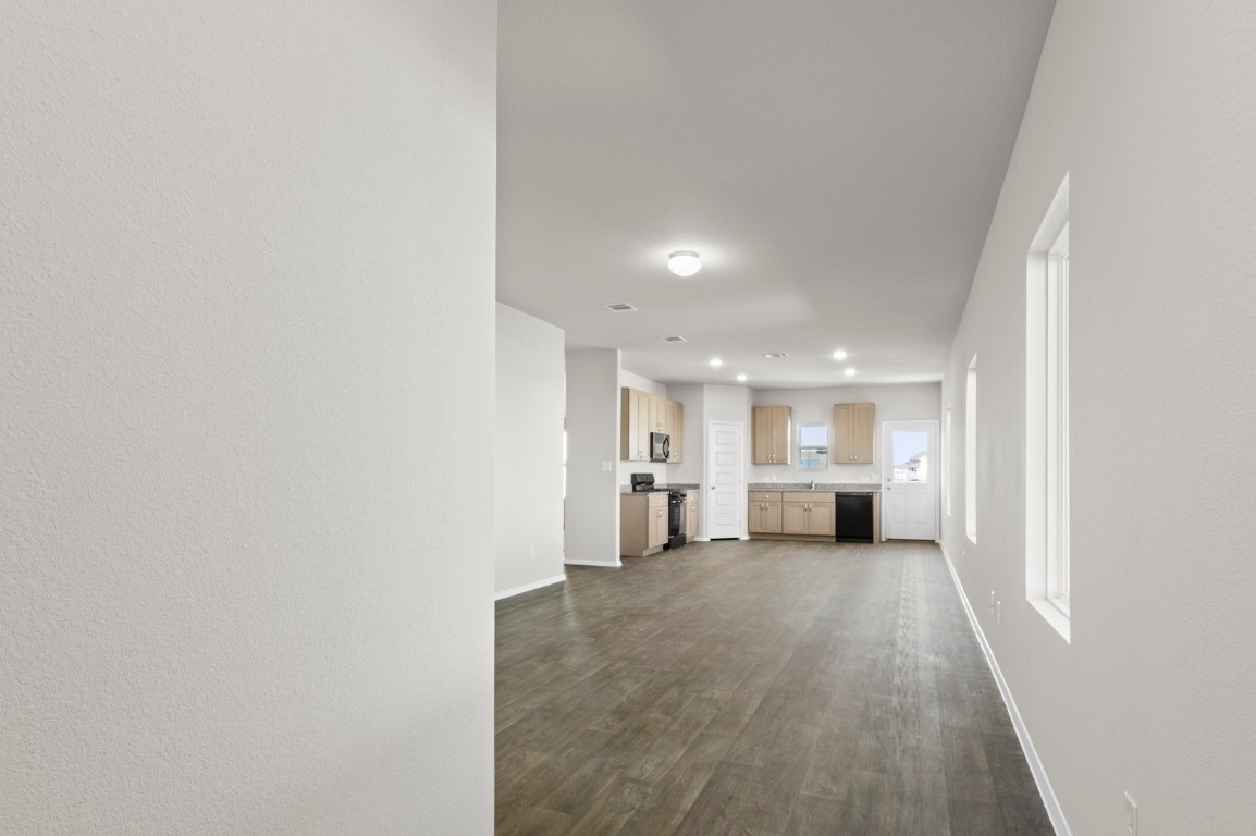 108 Summer Drive Elgin, TX 78621 - Photo 9 of 35 a view of a big room with wooden floor and a window