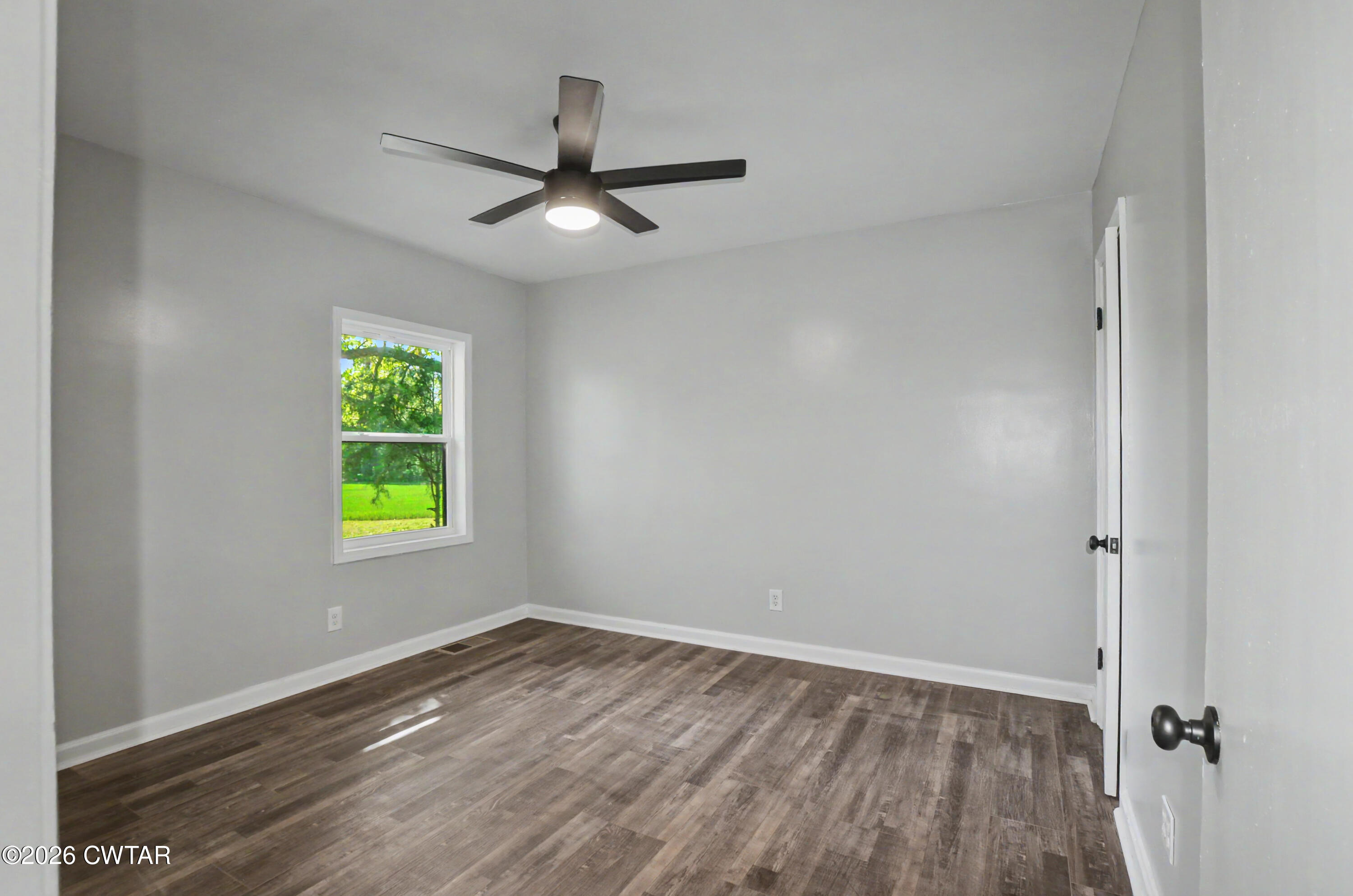 4177 Gum Flat Road Bells, TN 38006 - Photo 23 of 30 an empty room with a window and a ceiling fan