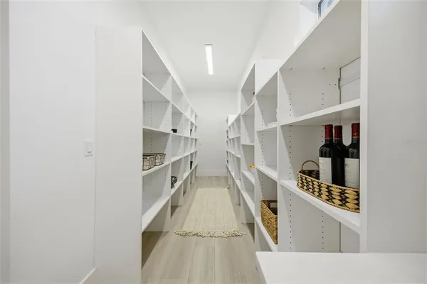a kitchen with stainless steel appliances granite countertop a stove and a white cabinet