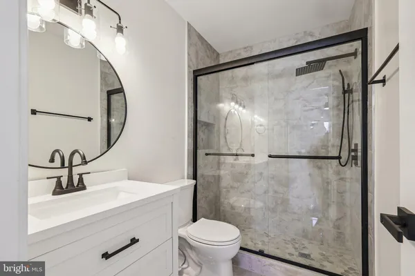 a bathroom with a sink toilet and a mirror
