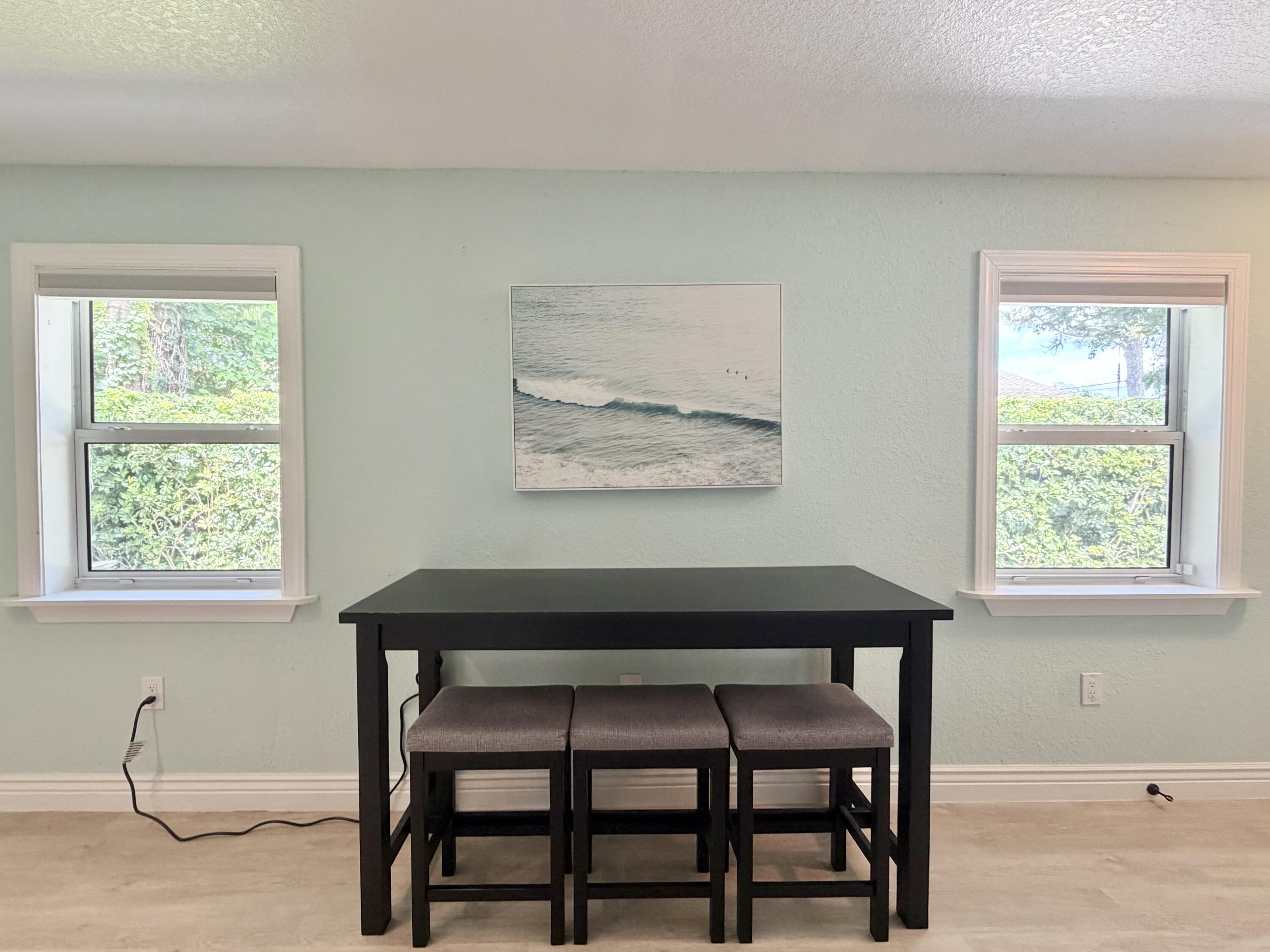 6100 Francis Street, Unit B Jupiter, FL 33458 - Photo 5 of 19 a dining room with a table and chairs