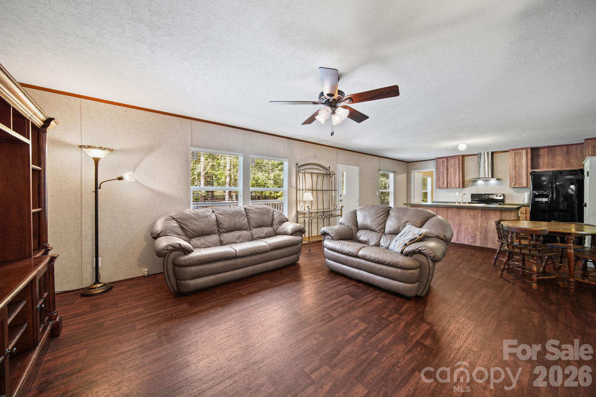 4507 White Store Road Wingate, NC 28174 - Photo 9 of 29 a living room with furniture flat screen tv and wooden floor