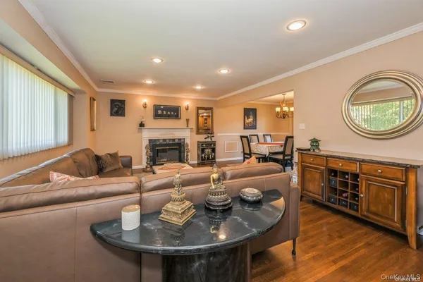 a living room with fireplace furniture and a wooden floor