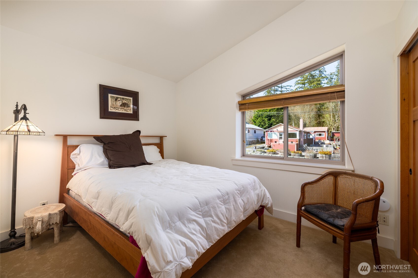 13207 Satterlee Road Anacortes, WA 98221 - Photo 28 of 40 a bedroom with a bed and a chair