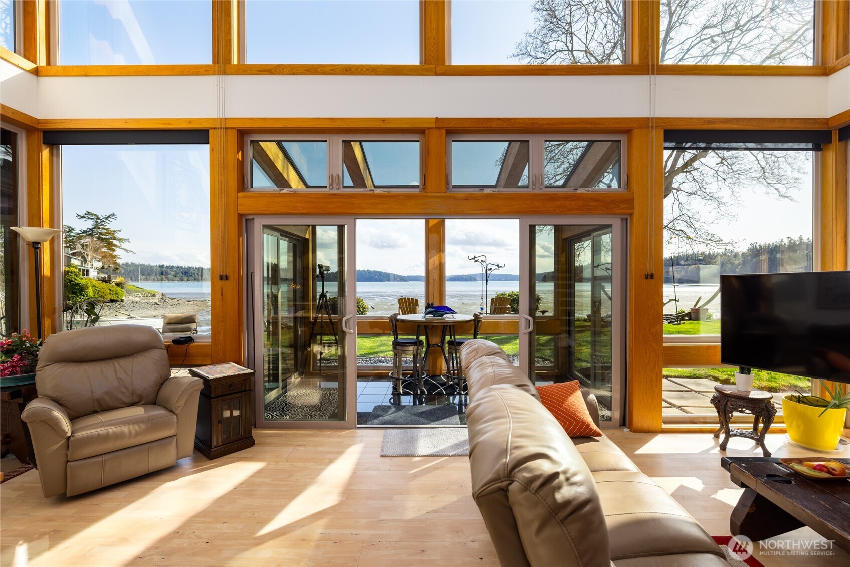 13207 Satterlee Road Anacortes, WA 98221 - Photo 8 of 40 a living room with furniture a flat screen tv and floor to ceiling window
