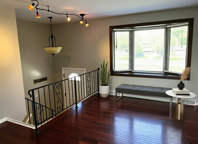 a view of a room with wooden floor and windows