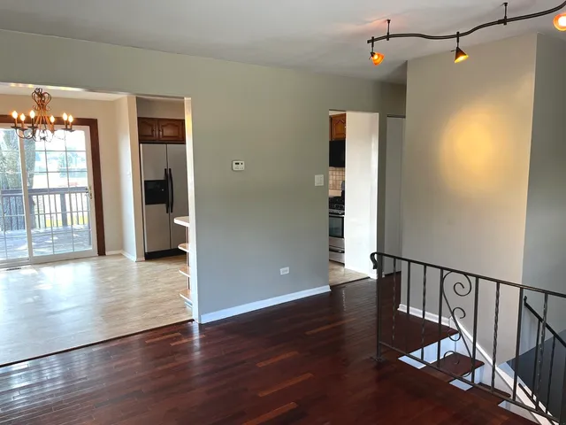a view of an entryway with wooden floor