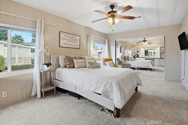 a bed room with a bed and a chandelier