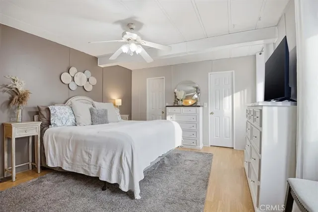 a spacious bedroom with a bed and a chandelier