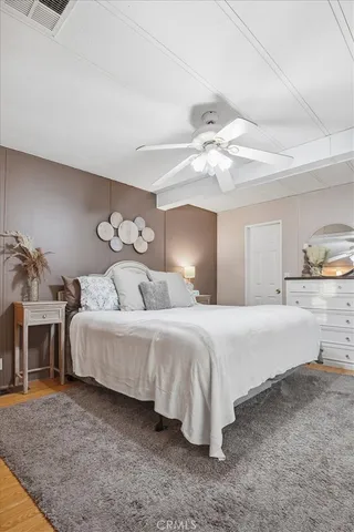 a spacious bedroom with a bed and a chandelier