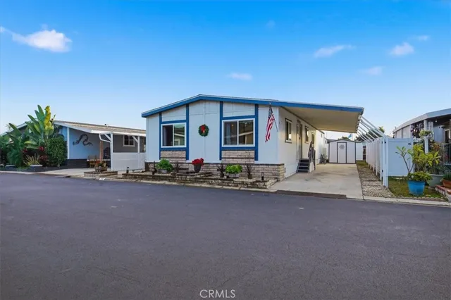 a front view of a house with yard and parking