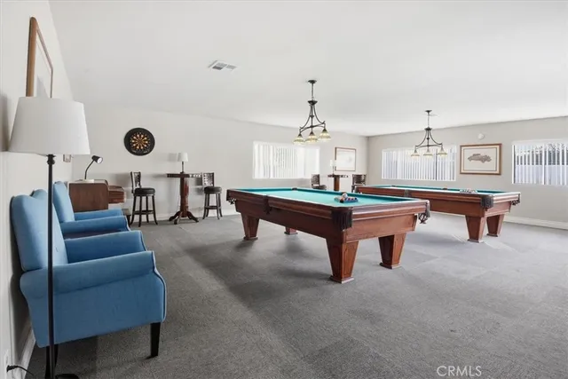 a view of a house with pool and chairs