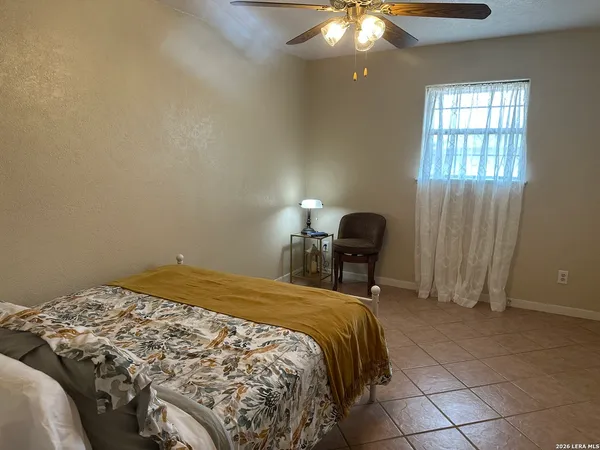 a bedroom with a bed and a chair