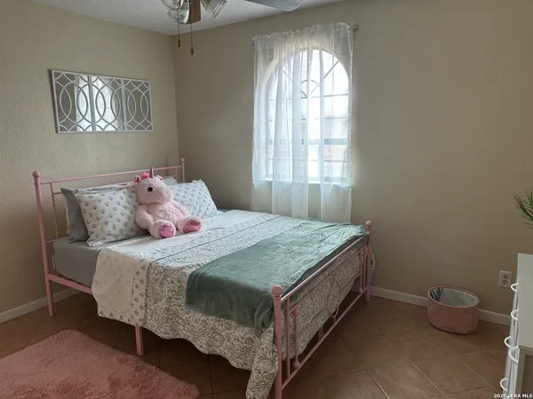 a bedroom with a bed and a window