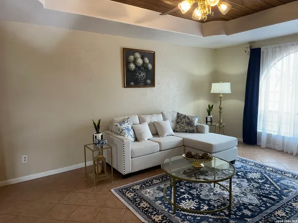 a living room with furniture and a chandelier