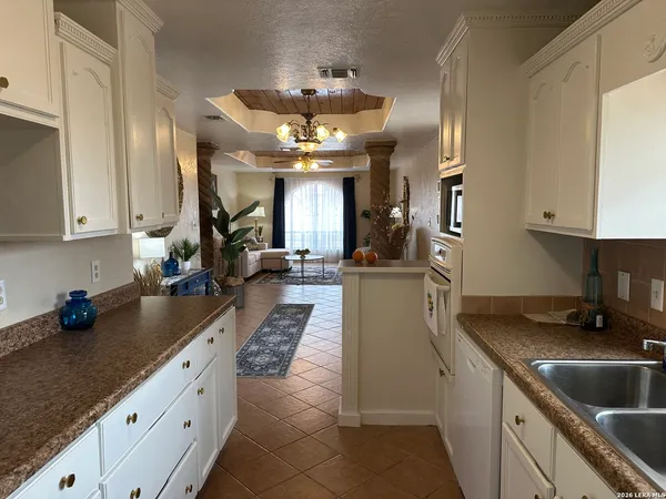 a kitchen with granite countertop a sink stainless steel appliances lots of counter space and stainless steel appliances