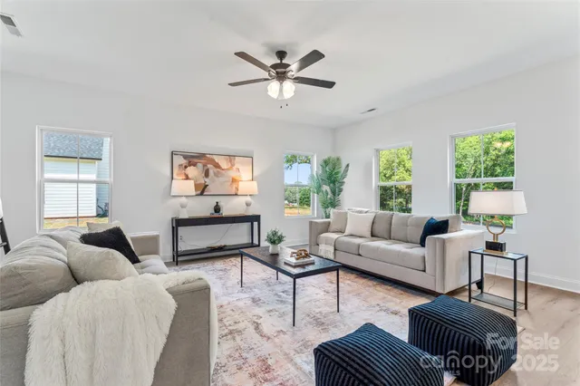 a living room with fireplace furniture and a wooden floor