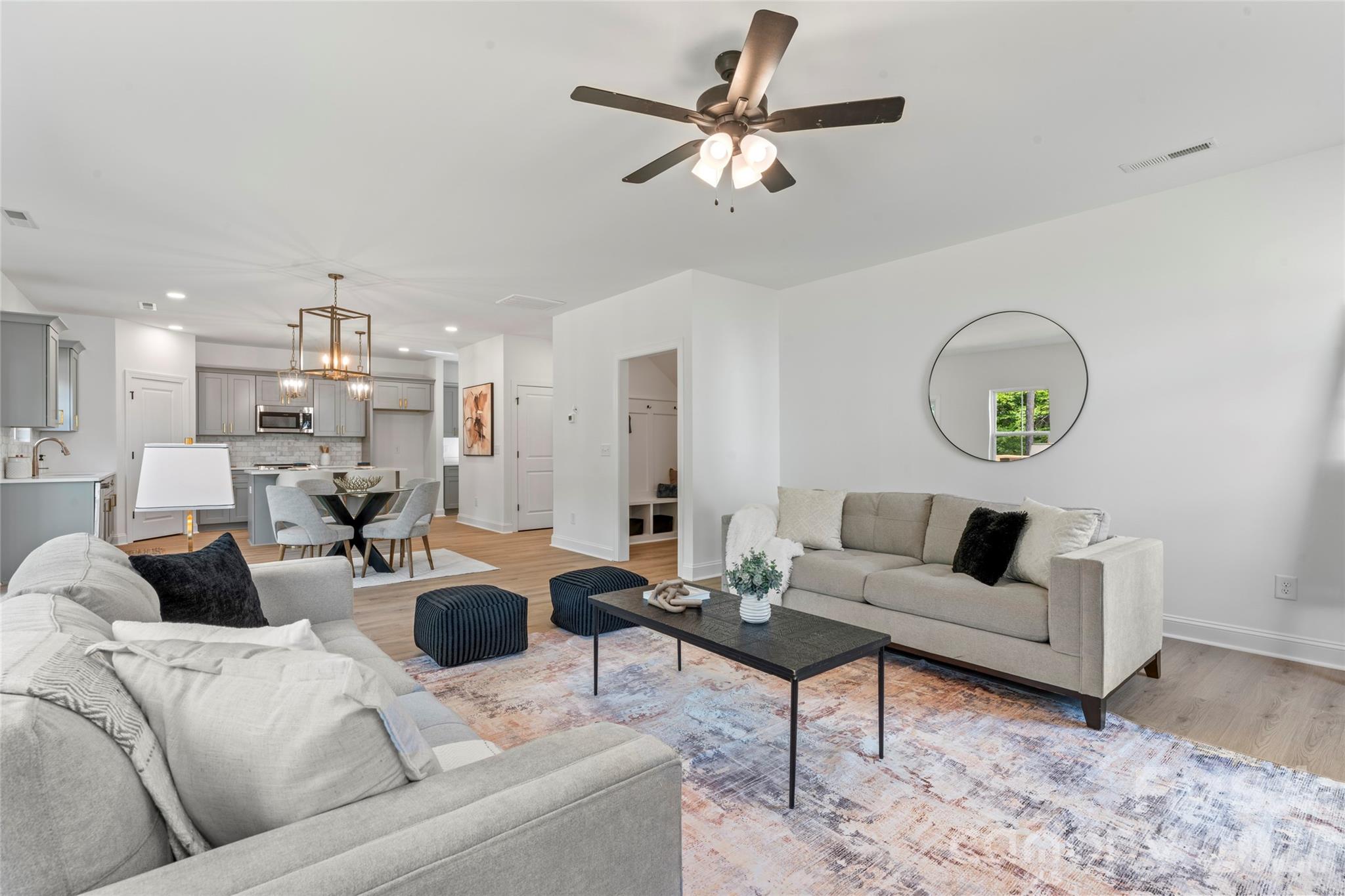 5234 Rocky River Crossing Road Harrisburg, NC 28075 - Photo 16 of 34 a living room with furniture and a chandelier