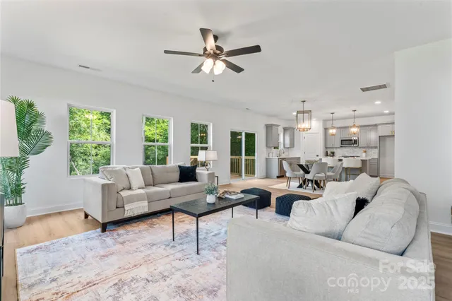 a living room with furniture and a chandelier