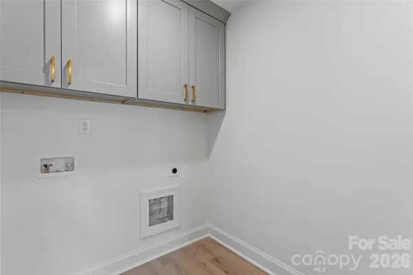 a spacious bedroom with a bed and a chandelier