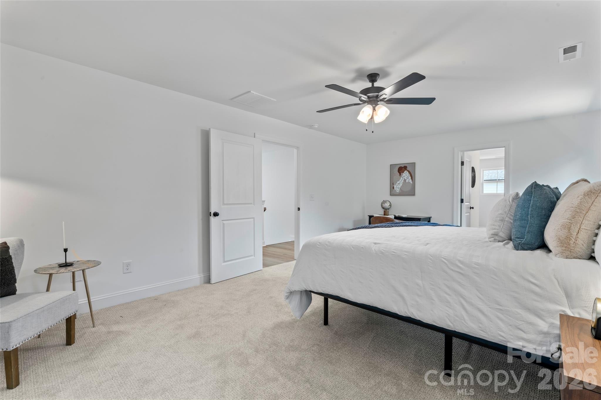 5234 Rocky River Crossing Road Harrisburg, NC 28075 - Photo 24 of 34 a bedroom with a bed and a ceiling fan