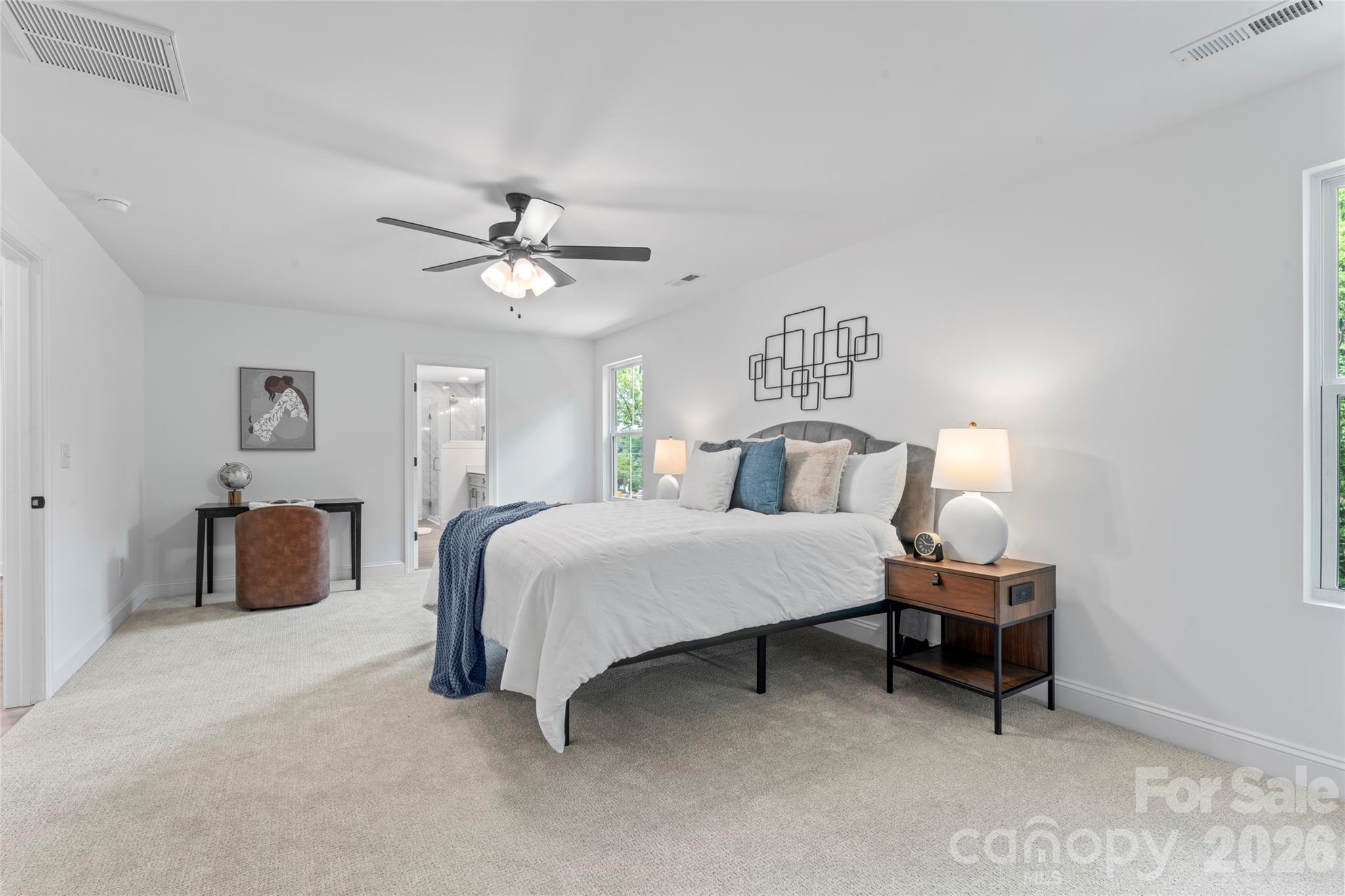 5234 Rocky River Crossing Road Harrisburg, NC 28075 - Photo 25 of 34 a spacious bedroom with a bed and a chandelier