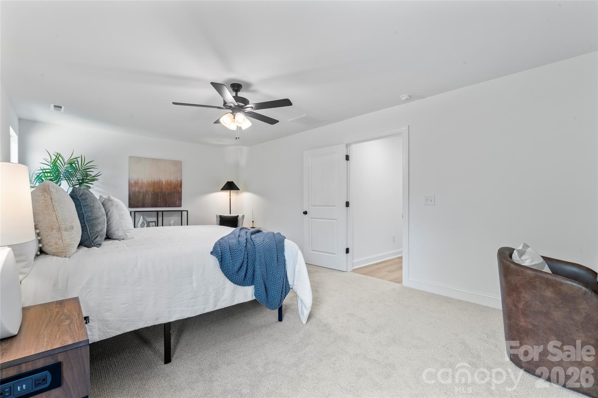 5234 Rocky River Crossing Road Harrisburg, NC 28075 - Photo 27 of 34 a bedroom with a bed and a chandelier