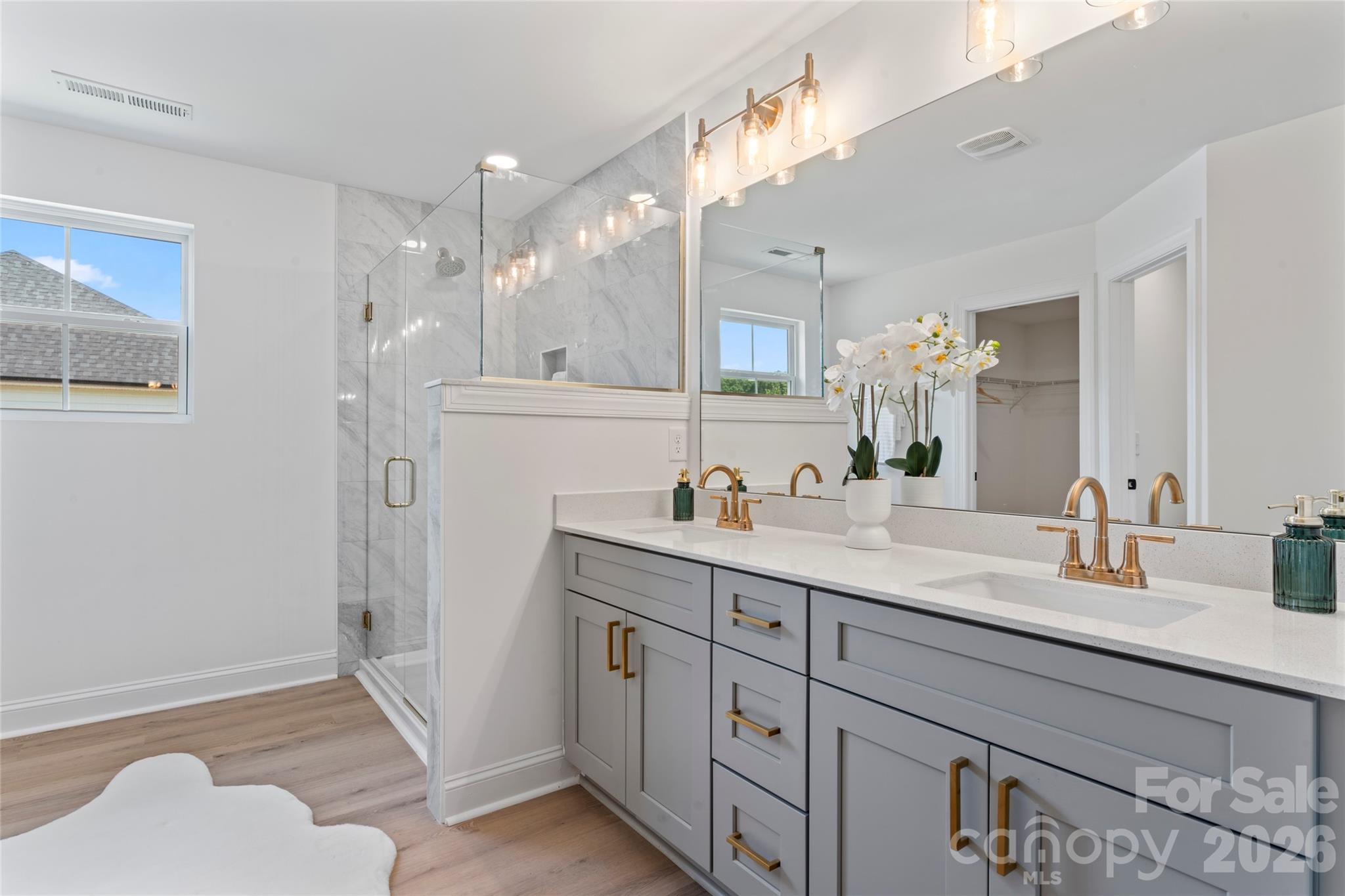 5234 Rocky River Crossing Road Harrisburg, NC 28075 - Photo 29 of 34 a bathroom with a sink vanity granite tub and a mirror