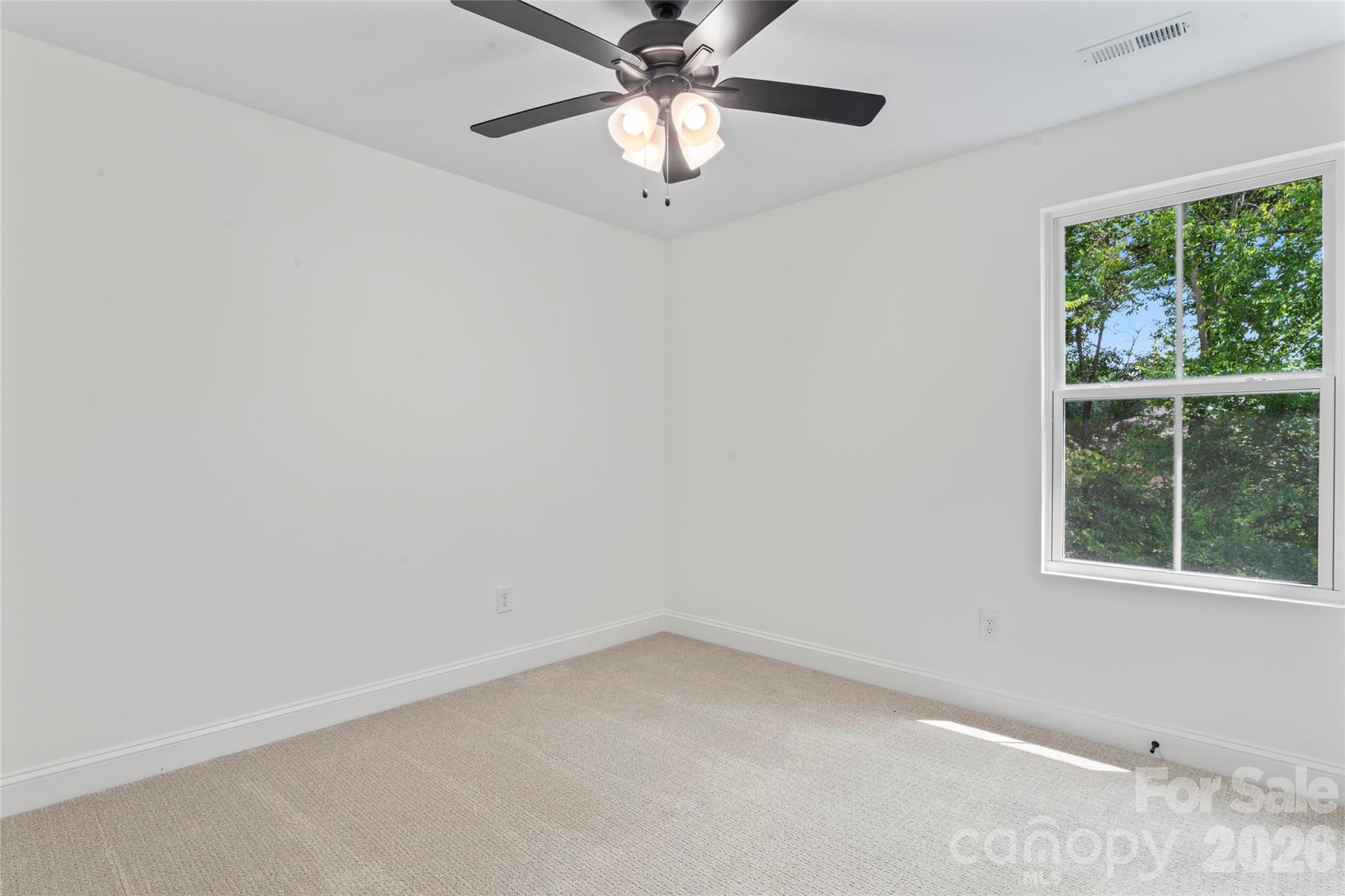 5234 Rocky River Crossing Road Harrisburg, NC 28075 - Photo 30 of 34 an empty room with a window and a fan