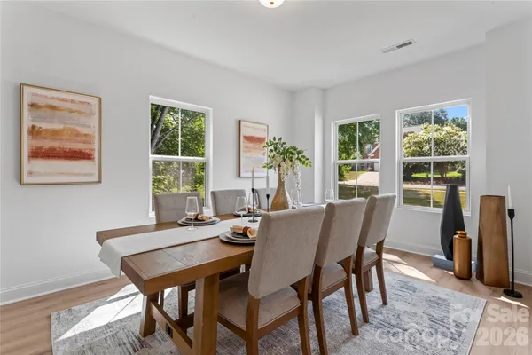 a view of a dining room with furniture and a potted plant