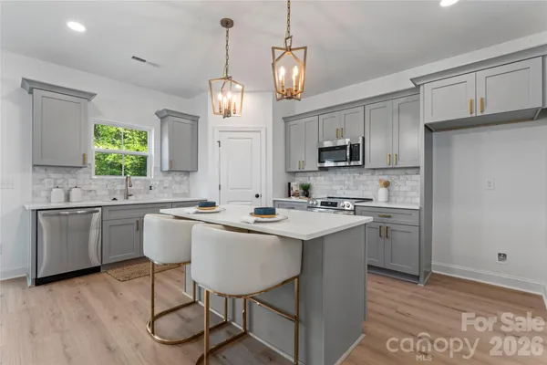 a kitchen with sink cabinets and wooden floor