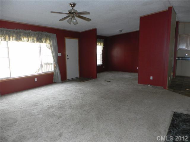2461 Campbell Lake Road Lancaster, SC 29720 - Photo 3 of 8 an empty room with windows and ceiling fan