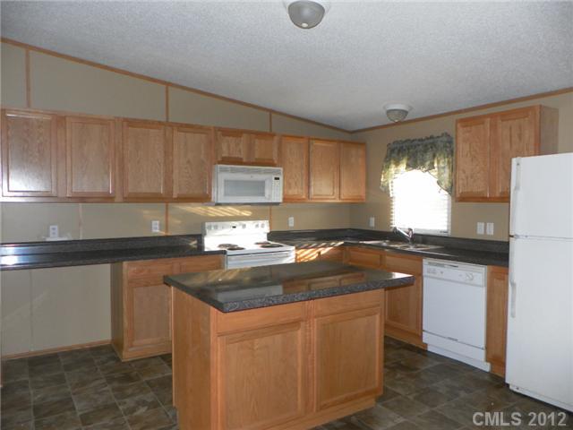 2461 Campbell Lake Road Lancaster, SC 29720 - Photo 4 of 8 a kitchen with granite countertop a sink stove and cabinets