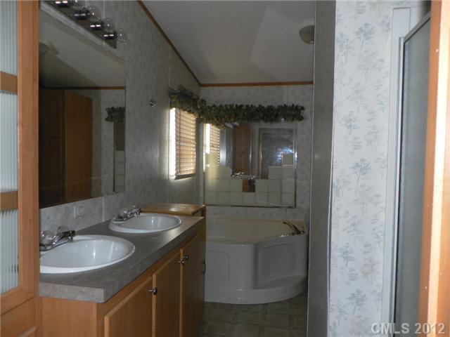 2461 Campbell Lake Road Lancaster, SC 29720 - Photo 7 of 8 a bathroom with a granite countertop sink and a mirror