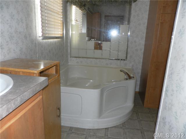 2461 Campbell Lake Road Lancaster, SC 29720 - Photo 8 of 8 a bath tub sitting in a bathroom and mirror