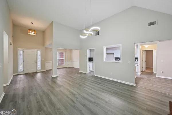 a spacious bathroom with a double vanity sink a mirror and a shower