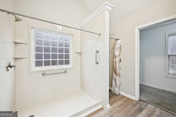 a view of a hallway with closet and bathroom