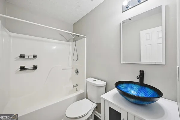 a bathroom with a toilet a sink and a shower