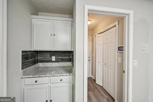 a view of bathroom with granite countertop window