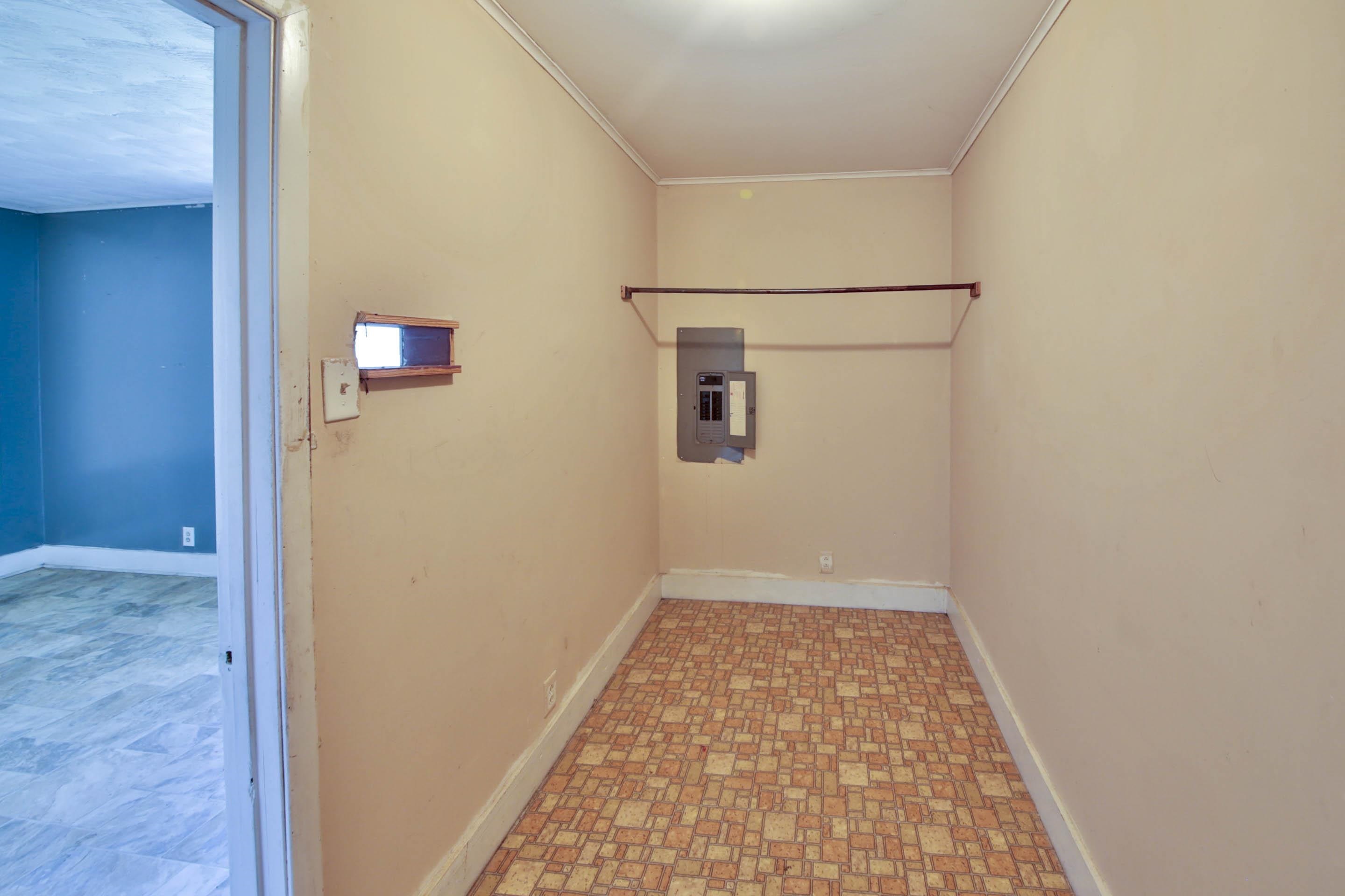 322 Highland Street Ripley, TN 38063 - Photo 12 of 12 Laundry room with crown molding and electric panel