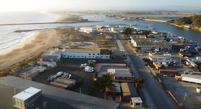 an aerial view of a city with ocean view