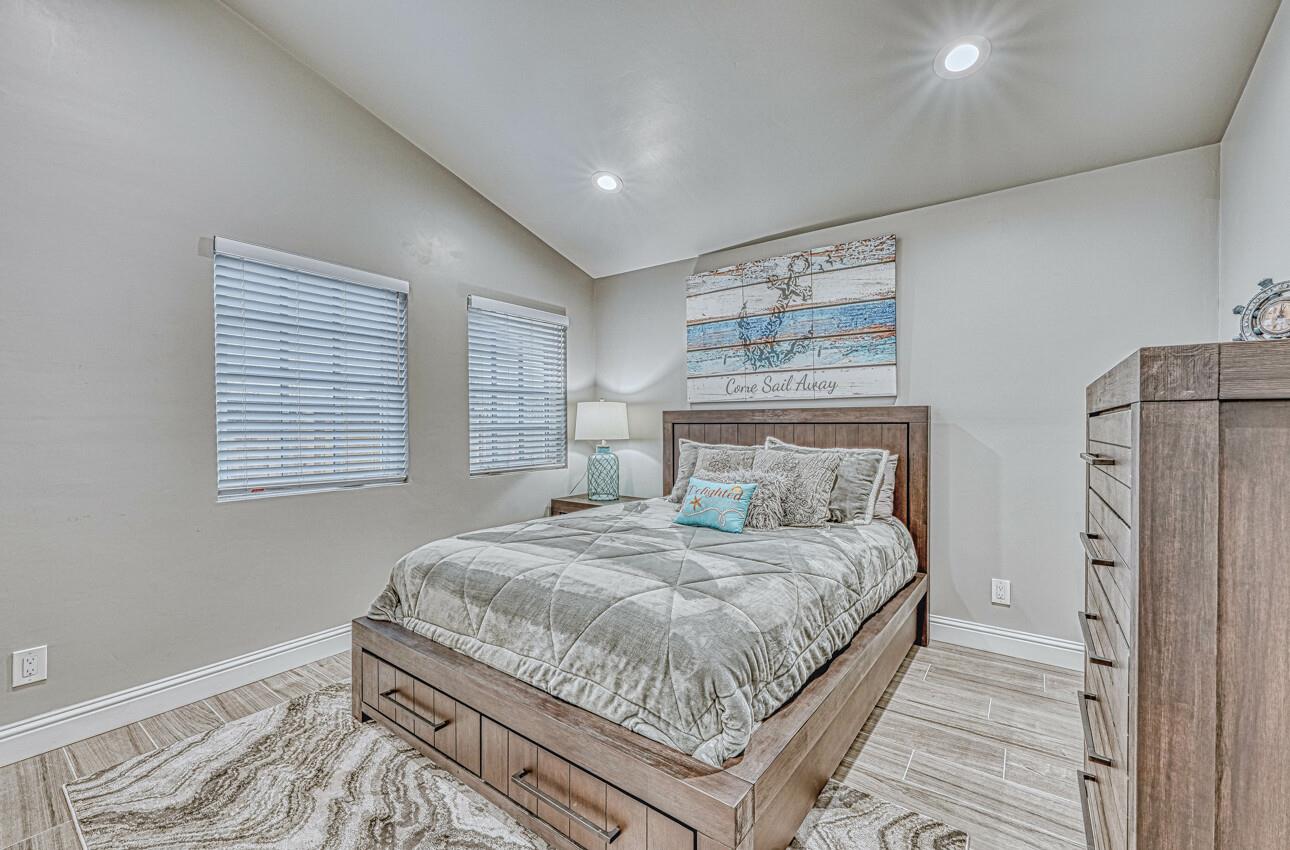 7550 Sandholdt Road Moss Landing, CA 95039 - Photo 18 of 85 a bedroom with a bed and a refrigerator