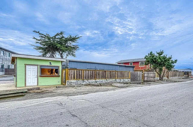 a view of a balcony with wooden floor and fence
