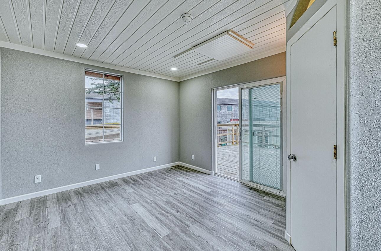 7550 Sandholdt Road Moss Landing, CA 95039 - Photo 48 of 85 a view of an empty room with wooden floor and a window