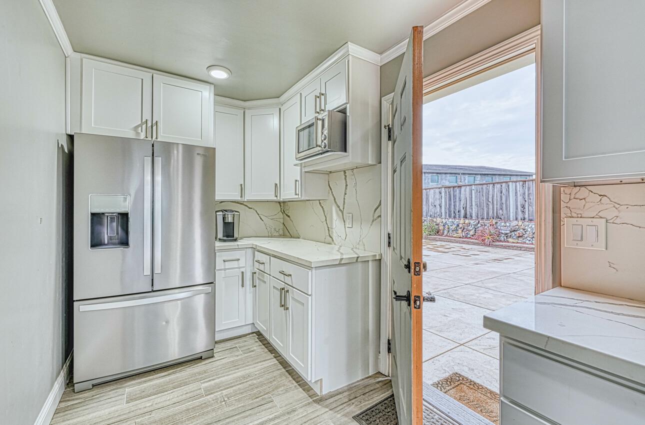 7550 Sandholdt Road Moss Landing, CA 95039 - Photo 10 of 85 a kitchen with stainless steel appliances a refrigerator sink and cabinets
