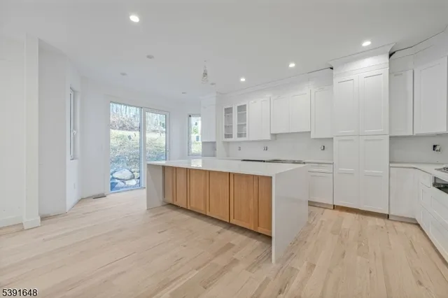 a large kitchen with a lot of counter space and stainless steel appliances