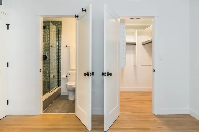 a bathroom with a sink mirror and a shower
