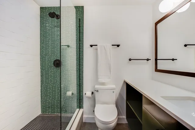 a bathroom with a toilet and a shower
