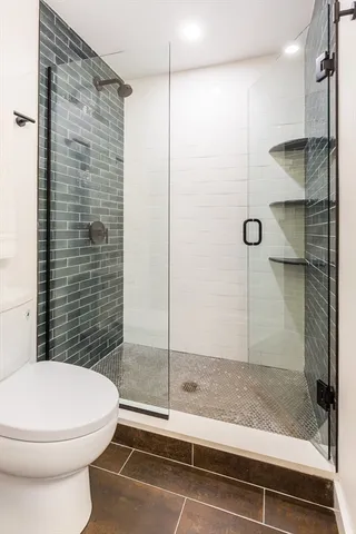 a bed sitting in a spacious bedroom next to a window